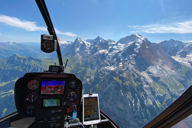 Private Swiss Alps helicopter tour over snow covered mountain peaks and glaciers - Eiger north face from the cockpit, plus Grindelwald valley context