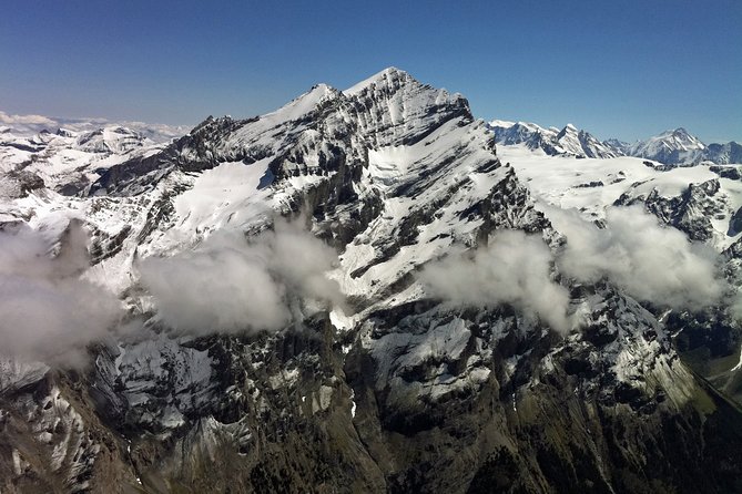 Private Swiss Alps helicopter tour over snow covered mountain peaks and glaciers - Interlaken from above: two lakes, one setting