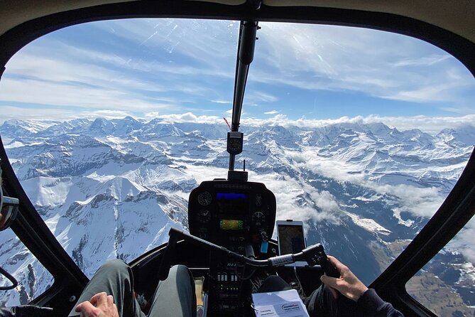 Private Swiss Alps helicopter tour over snow covered mountain peaks and glaciers - Lake Thun’s turquoise water and the glacier-fed color story